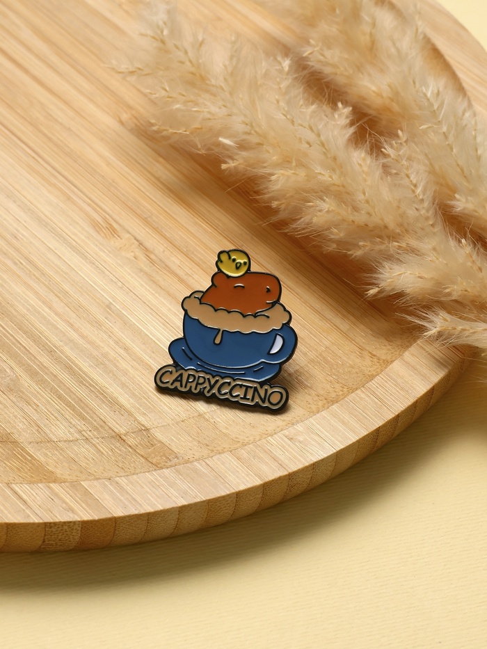 Значок «Капибара капучино», оранжево-синий в чёрном металле